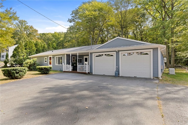 ranch-style home with a garage and covered porch