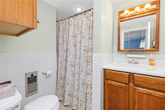 bathroom featuring vanity, tile patterned floors, toilet, tile walls, and heating unit