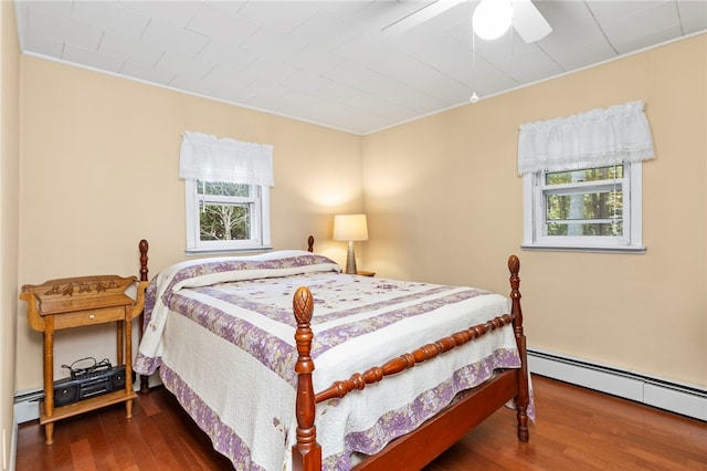 bedroom with multiple windows, hardwood / wood-style flooring, and ceiling fan