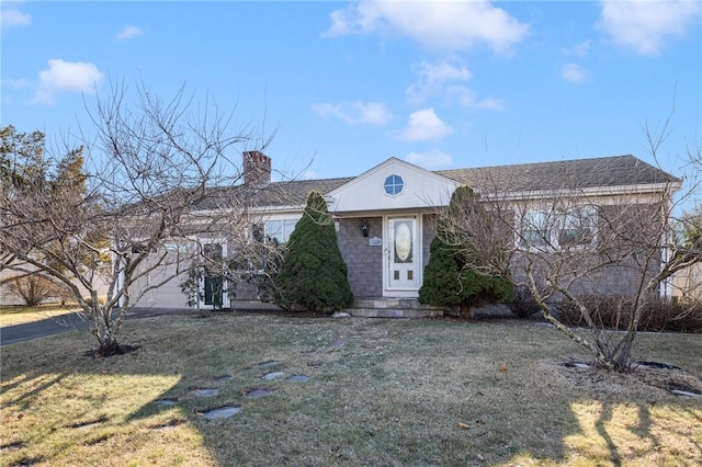 view of front of property featuring a garage and a front yard