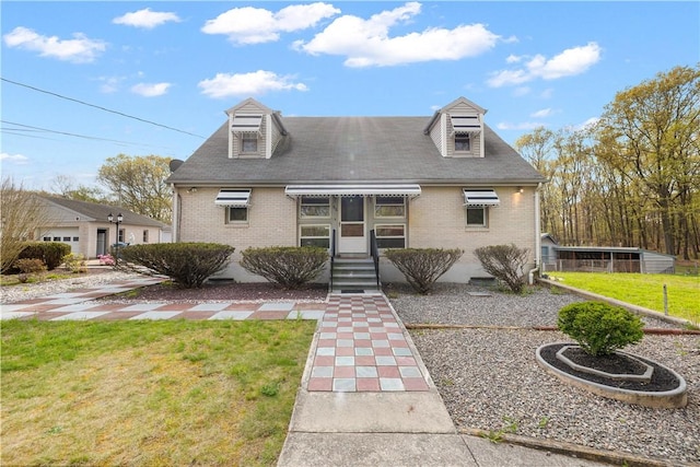 view of front of home featuring brick siding and a front lawn