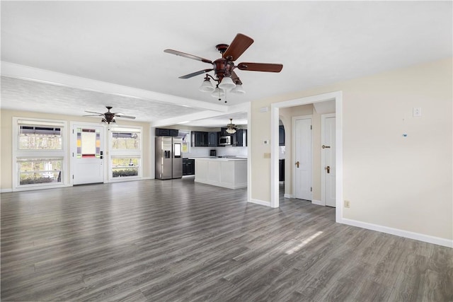 unfurnished living room with ceiling fan, baseboards, and dark wood-style flooring