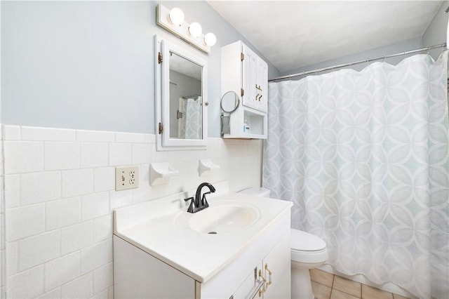 full bathroom featuring tile walls, toilet, vanity, a shower with curtain, and tile patterned floors