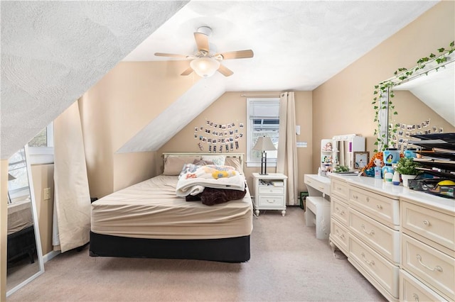 bedroom featuring light carpet, vaulted ceiling, and ceiling fan