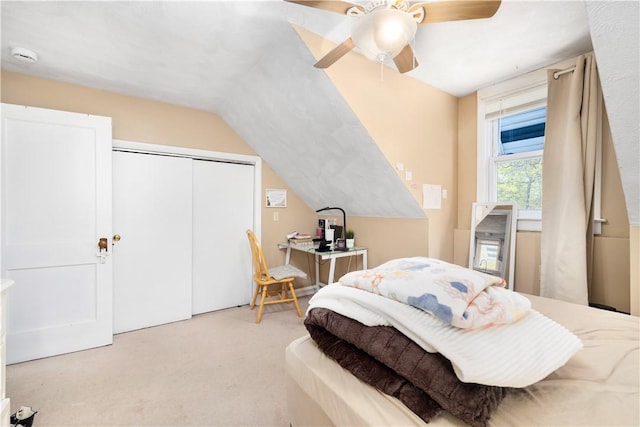 bedroom featuring lofted ceiling, a ceiling fan, a closet, and light colored carpet