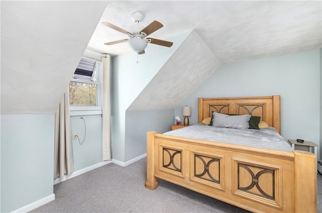 carpeted bedroom with lofted ceiling, baseboards, and a ceiling fan