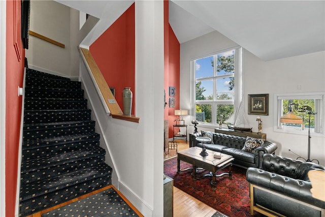 staircase featuring hardwood / wood-style floors and plenty of natural light