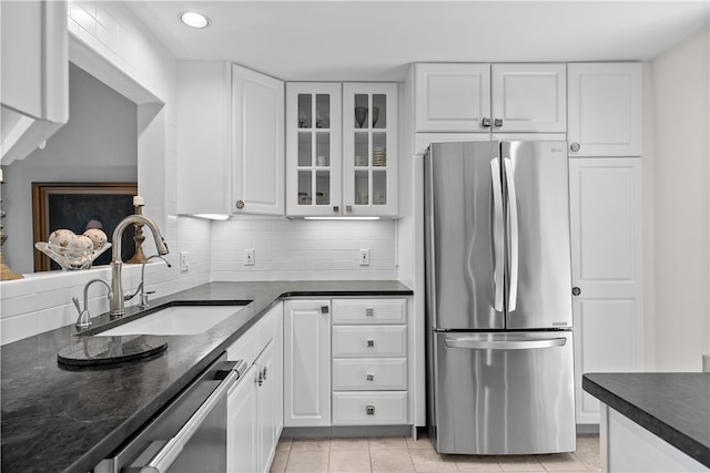 kitchen featuring white cabinets, sink, stainless steel appliances, and tasteful backsplash