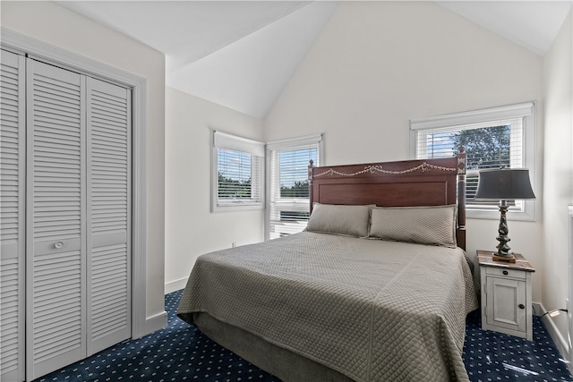 carpeted bedroom featuring vaulted ceiling and multiple windows