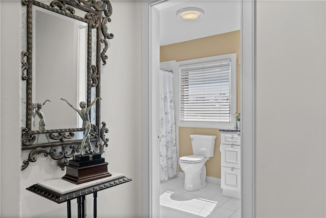 bathroom featuring tile patterned flooring and toilet