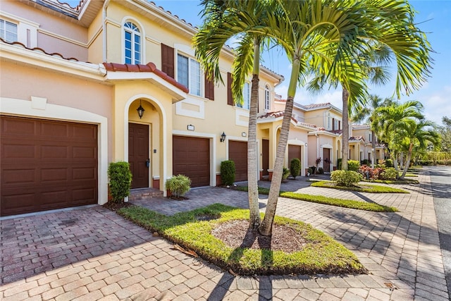 mediterranean / spanish-style home with a garage