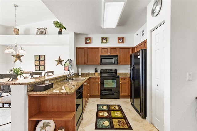 kitchen with kitchen peninsula, a chandelier, pendant lighting, a kitchen bar, and black appliances