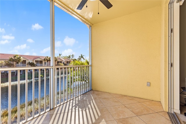 balcony featuring ceiling fan and a water view