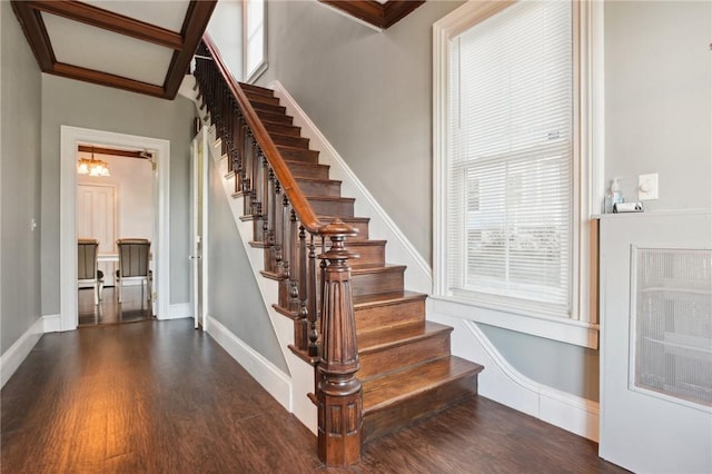 stairs with hardwood / wood-style flooring and a chandelier