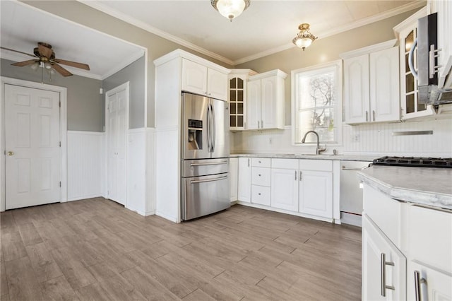 kitchen featuring dishwasher, crown molding, stainless steel fridge, light hardwood / wood-style floors, and white cabinetry