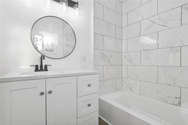 bathroom featuring vanity and tiled shower / bath combo