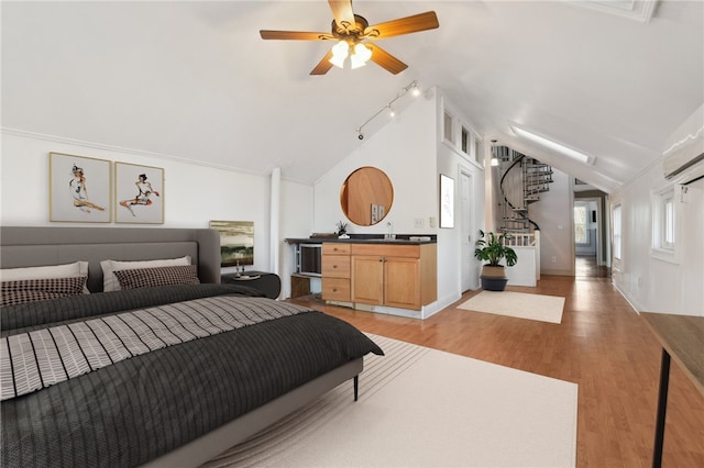 bedroom featuring ceiling fan, track lighting, wood-type flooring, and lofted ceiling