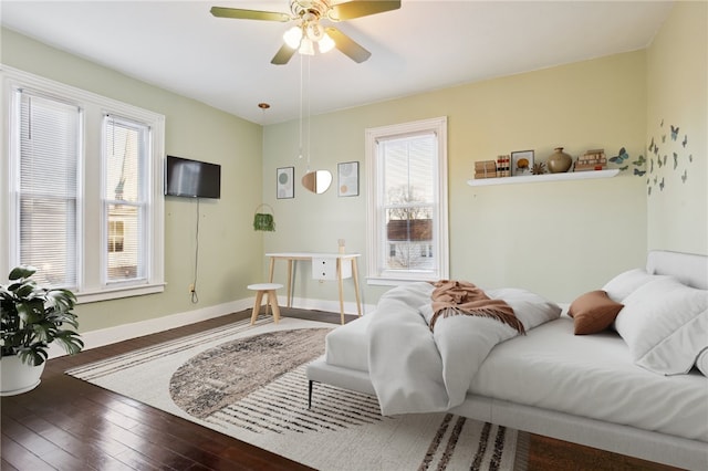 bedroom with hardwood / wood-style floors, multiple windows, and ceiling fan