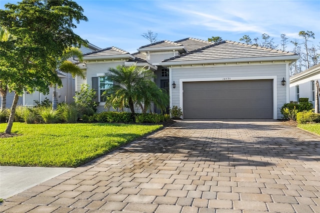 view of front of property featuring a garage and a front lawn