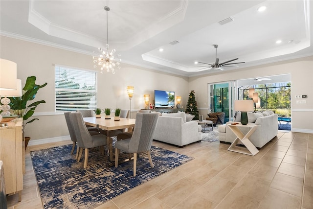 dining room featuring ornamental molding, a tray ceiling, and a healthy amount of sunlight