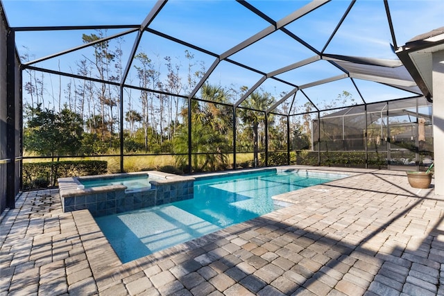 view of pool with an in ground hot tub, a patio, and glass enclosure