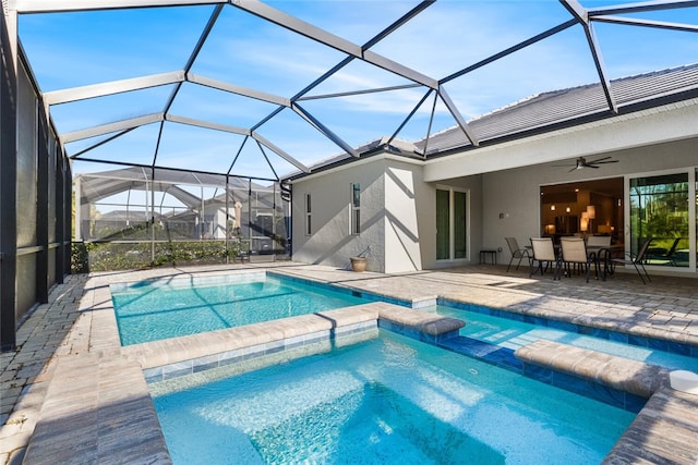 view of pool featuring ceiling fan, a patio, and glass enclosure