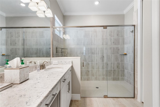 bathroom with tile patterned flooring, a shower with shower door, ornamental molding, and vanity