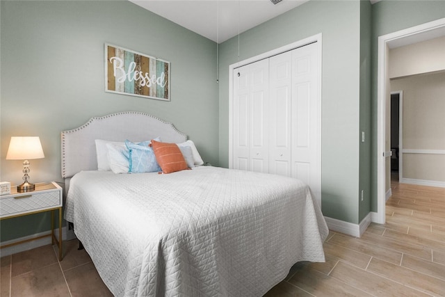 bedroom with hardwood / wood-style floors and a closet