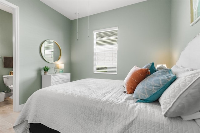 tiled bedroom featuring connected bathroom