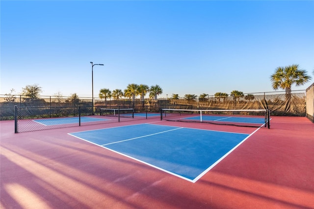 view of tennis court featuring basketball hoop