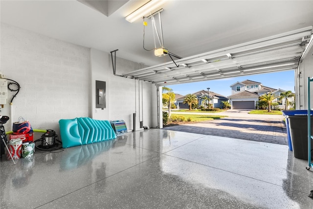 garage with electric panel and a garage door opener