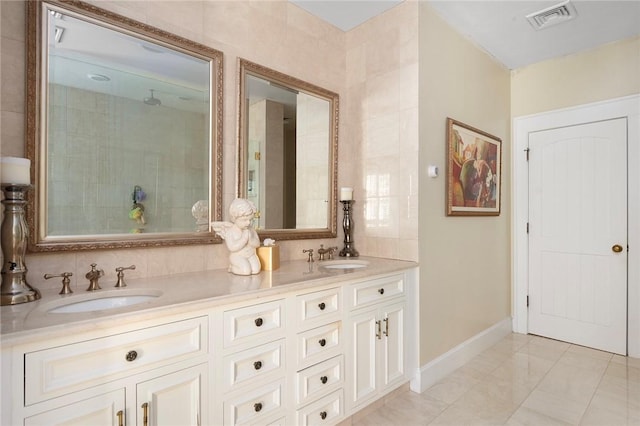 bathroom with vanity and tile walls