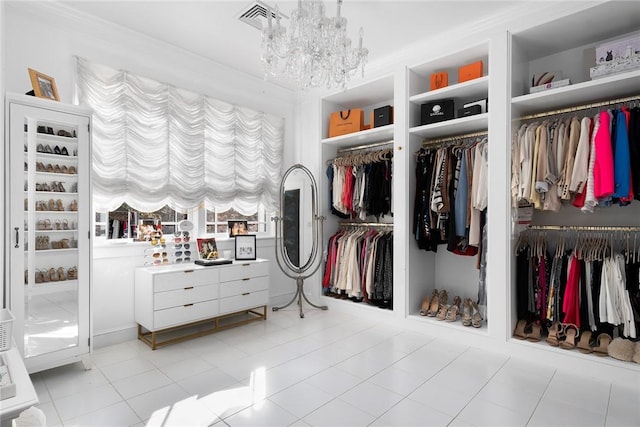 walk in closet with light tile patterned floors