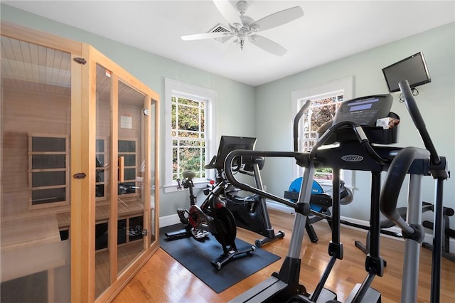 exercise room with french doors, hardwood / wood-style flooring, and ceiling fan