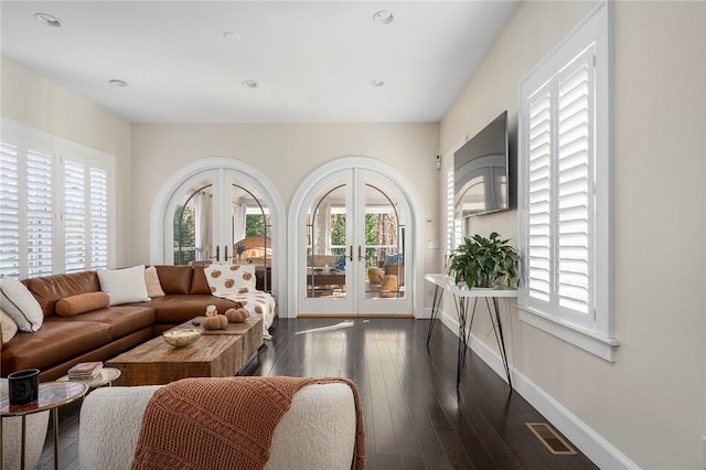 living room featuring dark hardwood / wood-style flooring and french doors