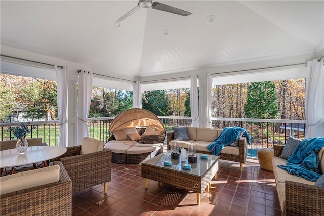 sunroom / solarium featuring ceiling fan and vaulted ceiling