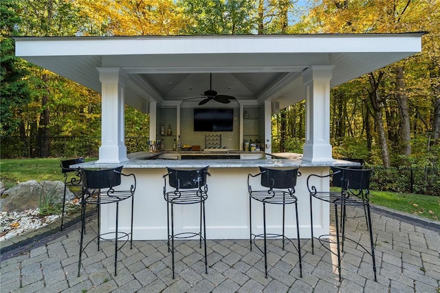 view of patio / terrace featuring ceiling fan and a bar