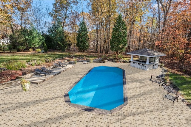 view of swimming pool with a gazebo, an outdoor bar, and a patio area