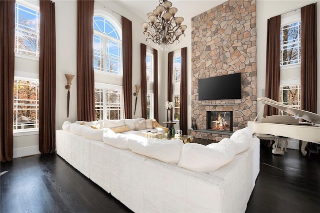 living room featuring a fireplace, dark hardwood / wood-style flooring, and a chandelier