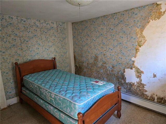 carpeted bedroom featuring a baseboard radiator