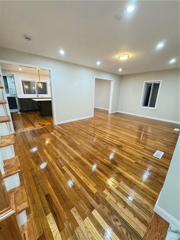 unfurnished living room featuring wood-type flooring