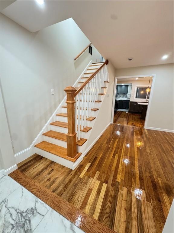 staircase with wood-type flooring