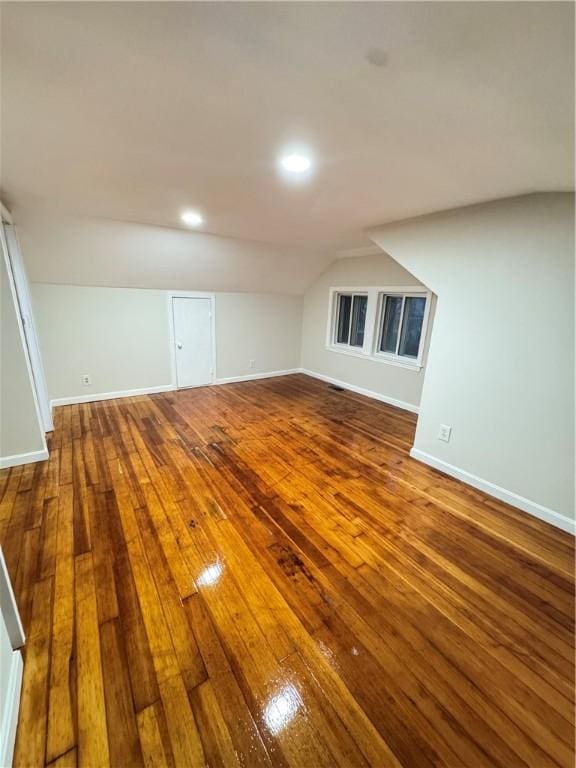 interior space featuring hardwood / wood-style floors and lofted ceiling