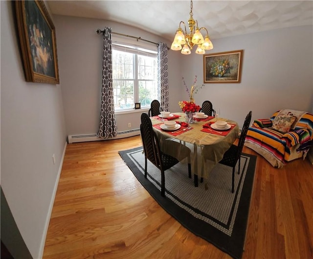 dining room with light hardwood / wood-style flooring, a notable chandelier, and a baseboard heating unit