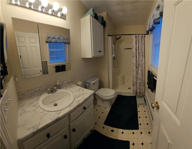 bathroom with tile patterned flooring, vanity, toilet, and curtained shower