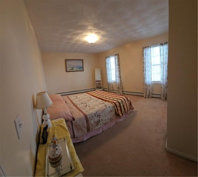 bedroom with baseboard heating and light carpet