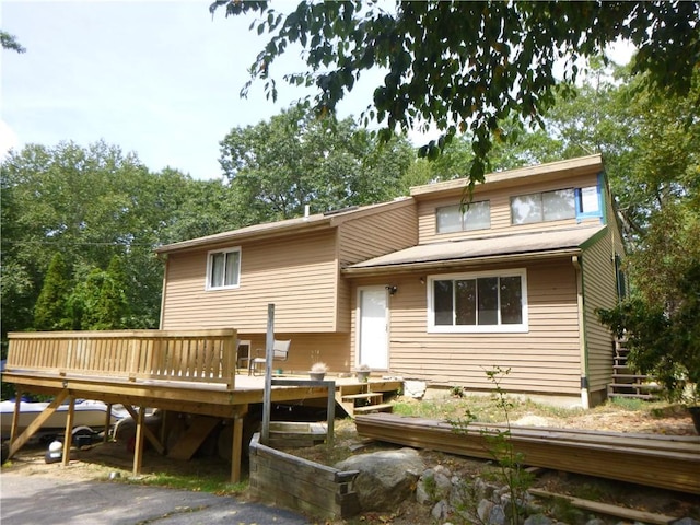 rear view of property with a wooden deck