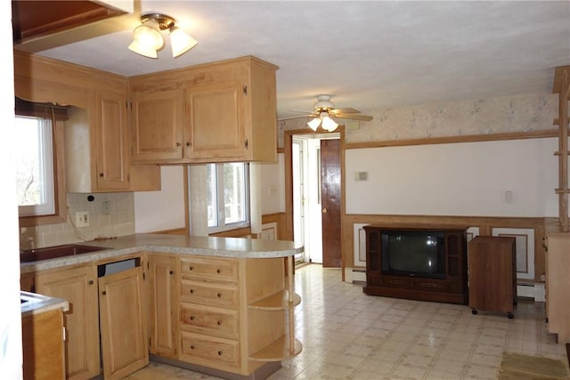 kitchen featuring kitchen peninsula, light brown cabinetry, ceiling fan, and a baseboard heating unit