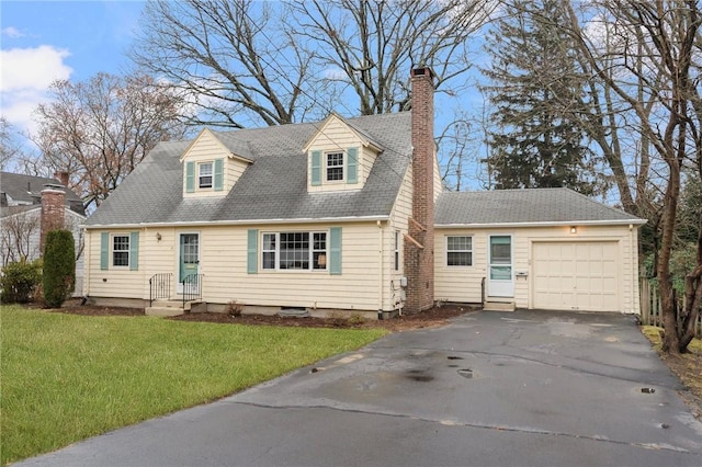 new england style home with a front yard and a garage