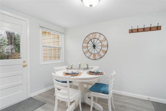 dining space with light hardwood / wood-style floors